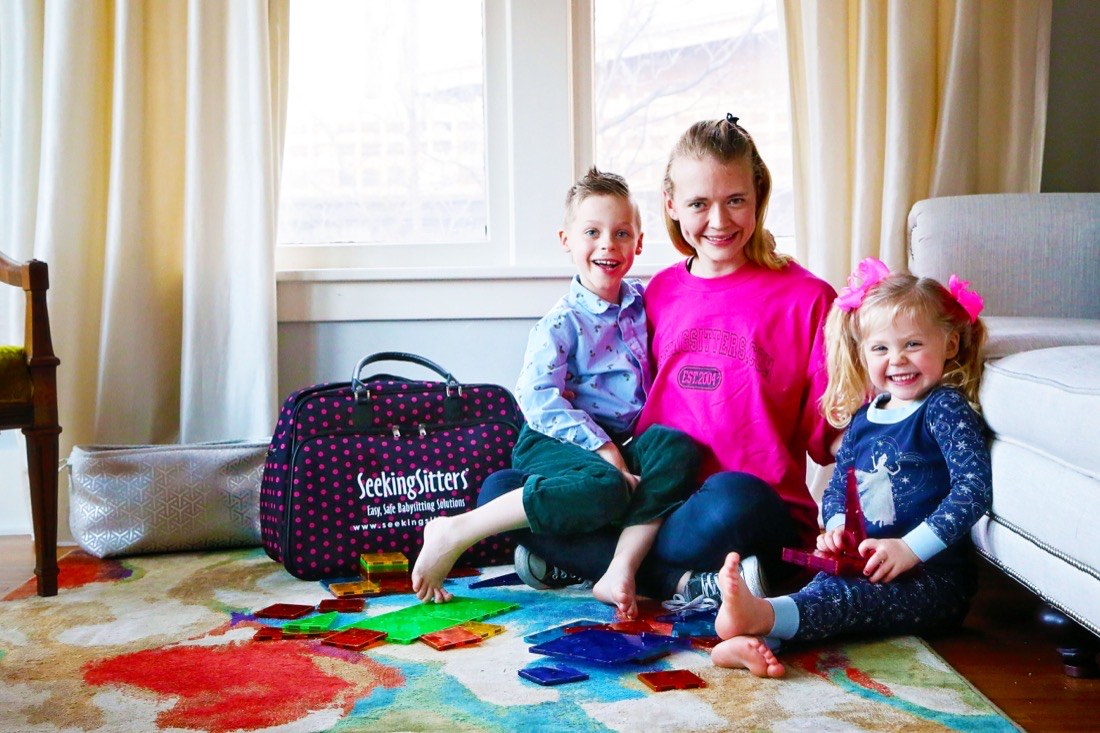 A SeekingSitters caregiver playing with two children